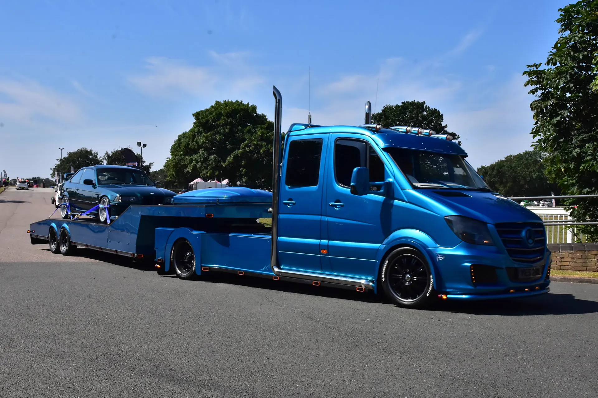 Custom blue Sprinter fifth-wheel truck with matching trailer