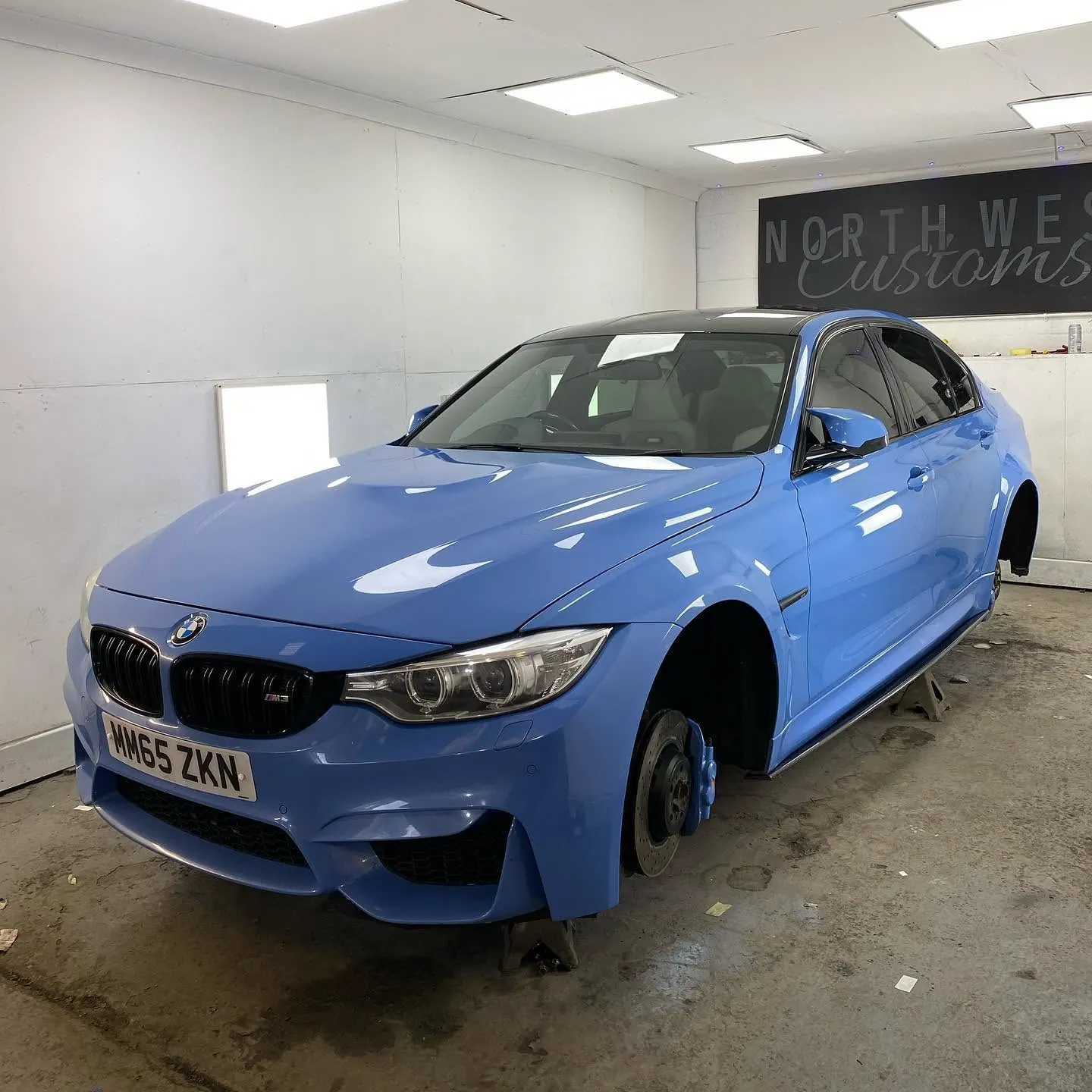BMW receiving a custom blue paint finish in the workshop