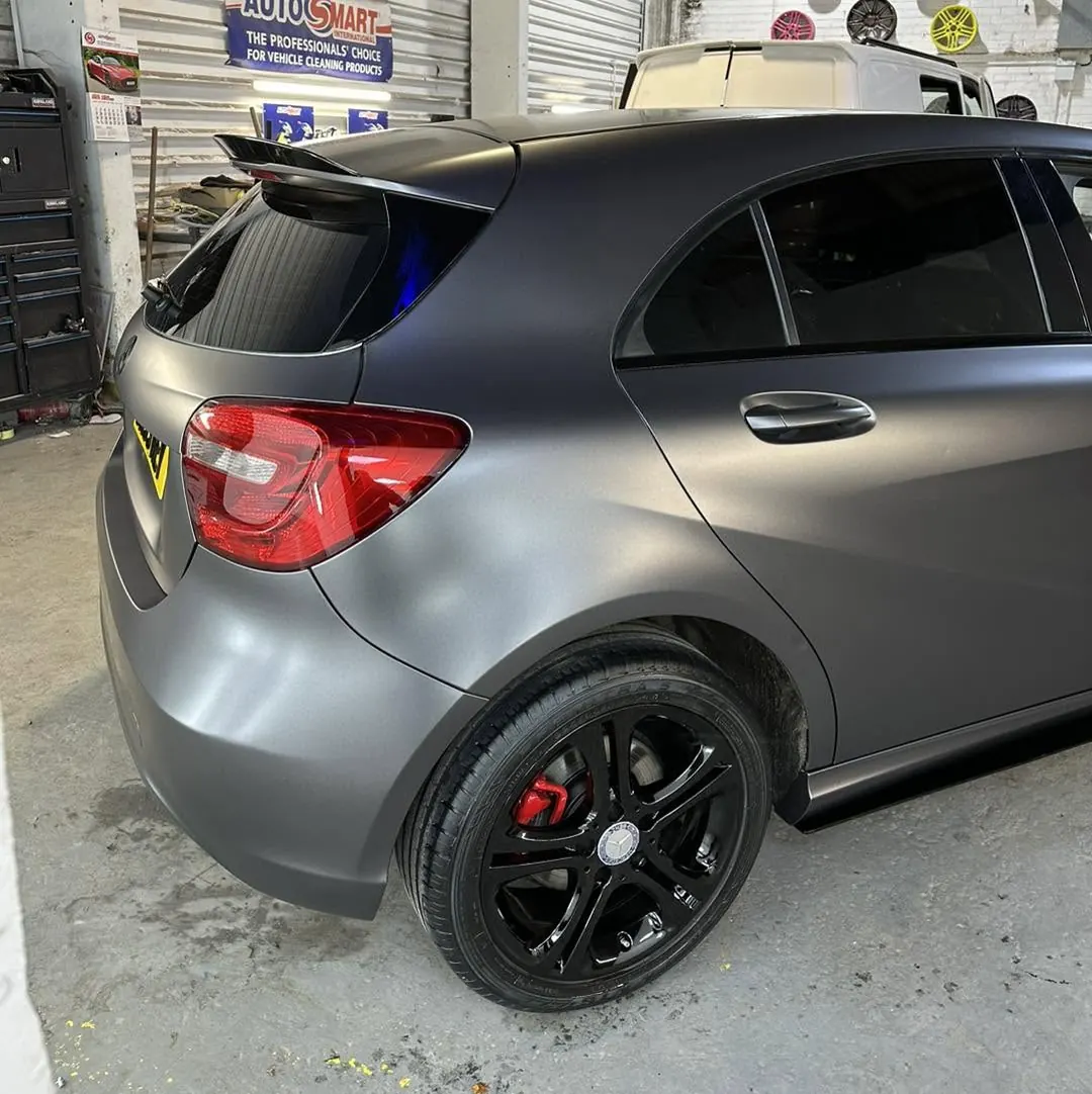 Mercedes body panel receiving a satin vinyl wrap